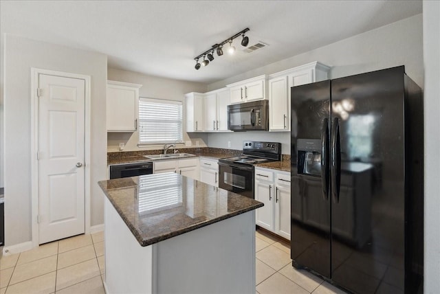 183 Dodge City Trl, Newark, TX 76071 - kitchen featuring black appliances, a sink, light tile patterned floors, and white cabinetry