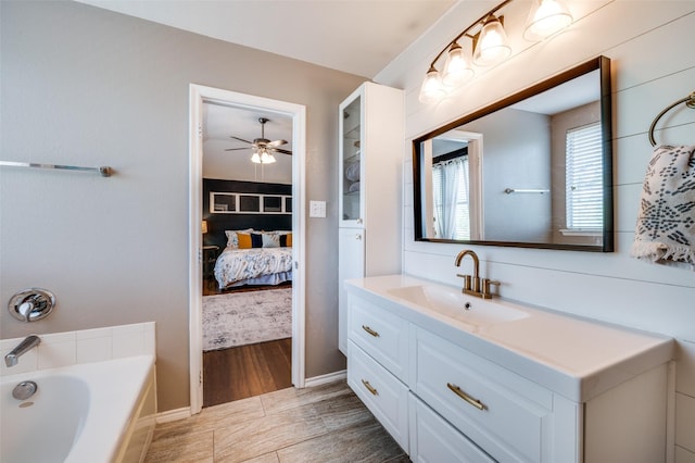 1405 Cardinal Way, Aubrey, TX 76227 - full bath with ensuite bath, vanity, a garden tub, a ceiling fan, and wood finished floors