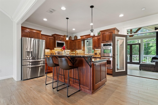 10443 County Road 3407, Brownsboro, TX 75756 - kitchen featuring appliances with stainless steel finishes, light wood-type flooring, a kitchen breakfast bar, plenty of natural light, and crown molding