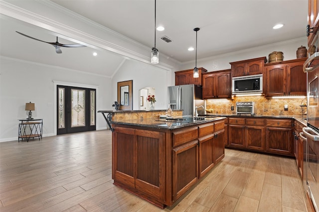 10443 County Road 3407, Brownsboro, TX 75756 - kitchen with built in microwave, stainless steel refrigerator with ice dispenser, a center island with sink, tasteful backsplash, and lofted ceiling