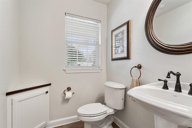 10443 County Road 3407, Brownsboro, TX 75756 - half bath with toilet, baseboards, a sink, and wood finished floors