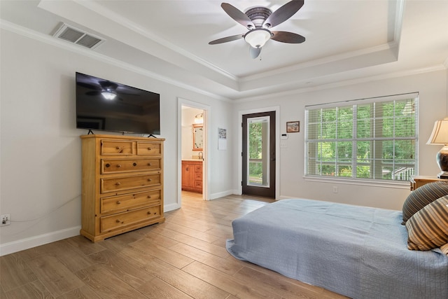 10443 County Road 3407, Brownsboro, TX 75756 - bedroom featuring a raised ceiling, light wood-type flooring, ornamental molding, ceiling fan, and ensuite bathroom