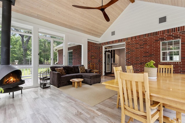 10443 County Road 3407, Brownsboro, TX 75756 - sunroom / solarium featuring a wood stove, lofted ceiling, and healthy amount of natural light