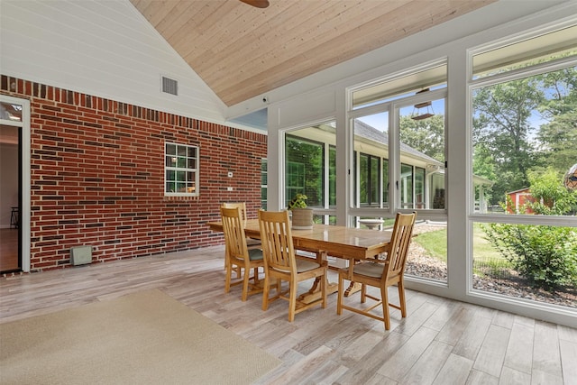 10443 County Road 3407, Brownsboro, TX 75756 - sunroom with wood ceiling, wood finished floors, brick wall, a deck, and high vaulted ceiling
