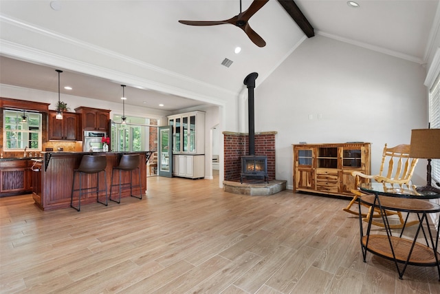 10443 County Road 3407, Brownsboro, TX 75756 - living area with a ceiling fan, a wood stove, light wood finished floors, ornamental molding, and recessed lighting