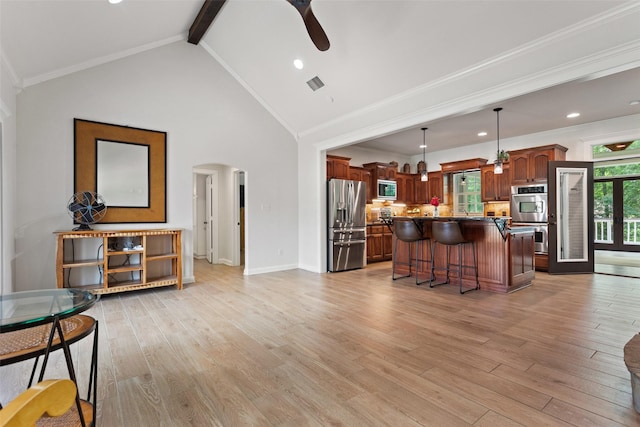 10443 County Road 3407, Brownsboro, TX 75756 - kitchen featuring stainless steel appliances, arched walkways, a ceiling fan, a breakfast bar area, and a center island
