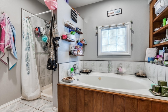 3622 Falls Dr, Dallas, TX 75211 - bathroom featuring a stall shower, a bath, and tile patterned floors