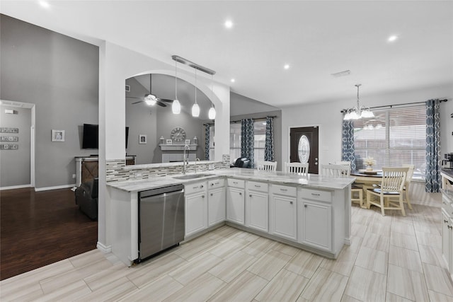 7113 Sundance Ln, Fort Worth, TX 76179 - kitchen featuring dishwasher, a sink, light stone counters, ceiling fan, and a chandelier