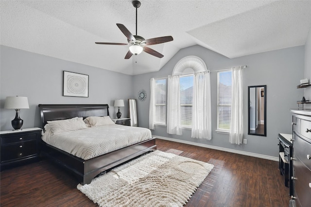 7113 Sundance Ln, Fort Worth, TX 76179 - bedroom with dark wood-style flooring, lofted ceiling, a textured ceiling, baseboards, and a ceiling fan