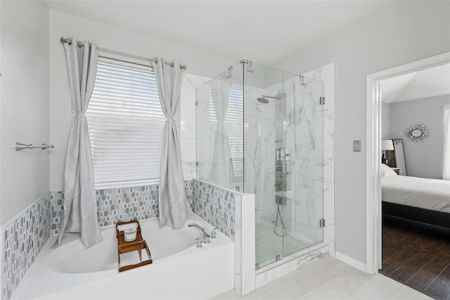 7113 Sundance Ln, Fort Worth, TX 76179 - ensuite bathroom with a garden tub, a marble finish shower, and baseboards