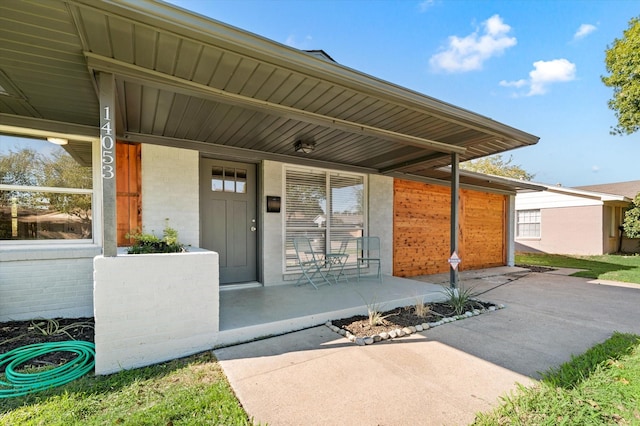 14053 Stardust Ln, Farmers Branch, TX 75234 - view of exterior entry with covered porch and brick siding