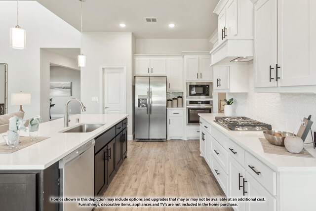 12709 Cactus Ct, Godley, TX 76044 - kitchen with appliances with stainless steel finishes, a sink, tasteful backsplash, white cabinetry, and light countertops