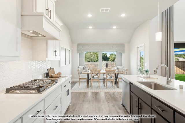 12709 Cactus Ct, Godley, TX 76044 - kitchen with a sink, appliances with stainless steel finishes, light countertops, white cabinetry, and lofted ceiling