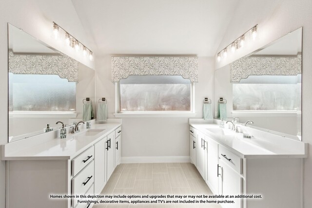 12709 Cactus Ct, Godley, TX 76044 - bathroom featuring two vanities, baseboards, and vaulted ceiling
