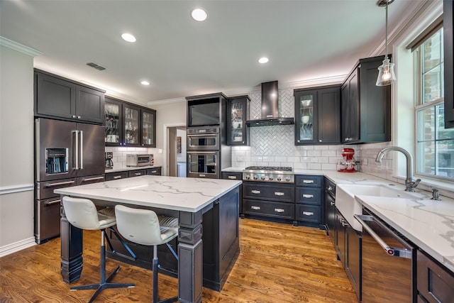 6801 Fm 2709, Athens, TX 75752 - kitchen with stainless steel appliances, wall chimney exhaust hood, ornamental molding, tasteful backsplash, and light stone countertops