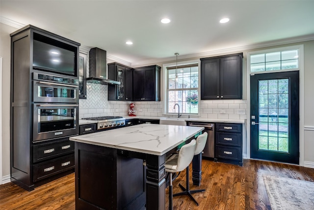6801 Fm 2709, Athens, TX 75752 - kitchen with appliances with stainless steel finishes, wall chimney exhaust hood, a sink, a center island, and ornamental molding