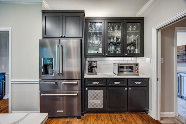 6801 Fm 2709, Athens, TX 75752 - bar area with high end refrigerator, crown molding, dark wood-style floors, backsplash, and baseboards