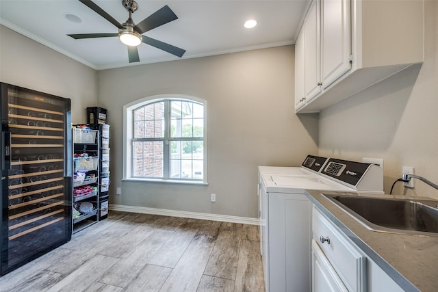 6801 Fm 2709, Athens, TX 75752 - washroom with wine cooler, cabinet space, washing machine and dryer, light wood-style floors, and baseboards