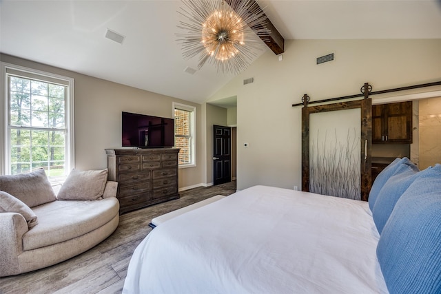 6801 Fm 2709, Athens, TX 75752 - bedroom with a chandelier, wood finished floors, and a barn door