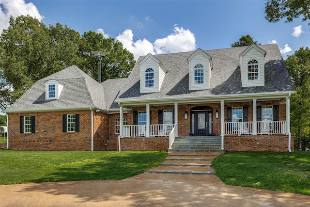 6801 Fm 2709, Athens, TX 75752 - cape cod house featuring brick siding, a front yard, a shingled roof, and a porch