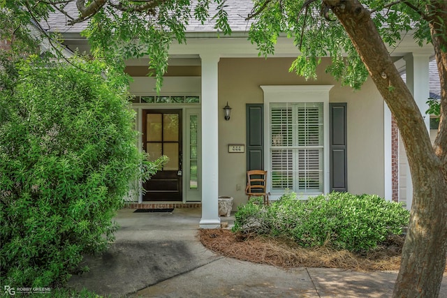 444 Grand Oaks Dr, Shreveport, LA 71106 - view of exterior entry featuring stucco siding and covered porch