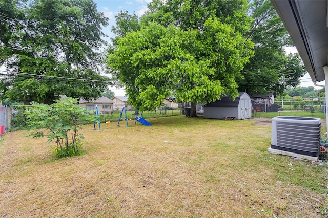 614 Edgedale, Dallas, TX 75232 - view of yard featuring central AC and a playground