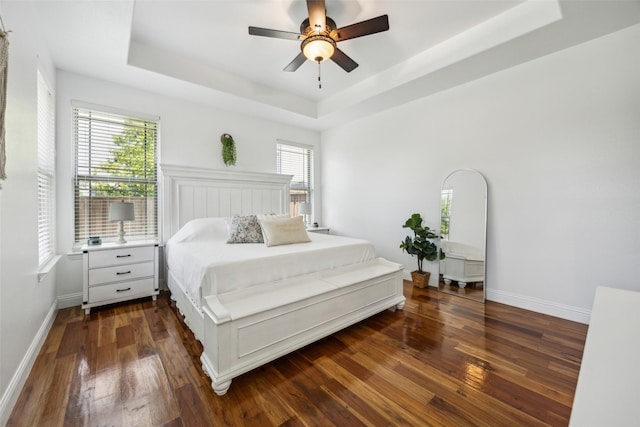 2405 La Costa Dr, Rowlett, TX 75088 - bedroom with a tray ceiling, wood finished floors, baseboards, and a ceiling fan
