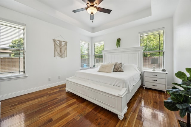 2405 La Costa Dr, Rowlett, TX 75088 - bedroom with a raised ceiling, dark wood-style flooring, baseboards, and a ceiling fan