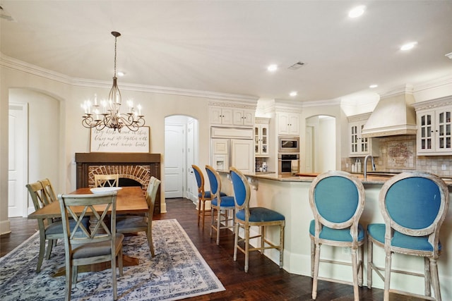 304 Van Oaks Dr, Colleyville, TX 76034 - dining area with arched walkways, recessed lighting, a chandelier, dark wood finished floors, and baseboards