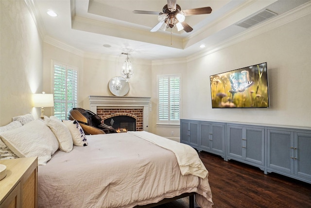 304 Van Oaks Dr, Colleyville, TX 76034 - bedroom with dark wood-style floors, multiple windows, a brick fireplace, ornamental molding, and a ceiling fan