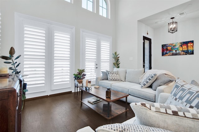 3736 Queen Rd, Sherman, TX 75090 - living area featuring wood finished floors, a chandelier, and a towering ceiling