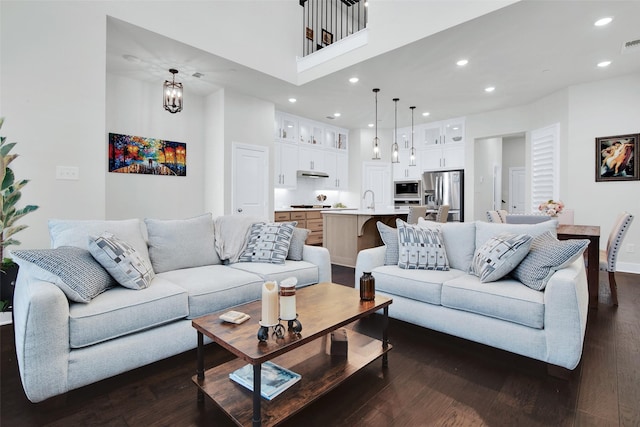 3736 Queen Rd, Sherman, TX 75090 - living area featuring dark wood-type flooring, recessed lighting, a high ceiling, and baseboards