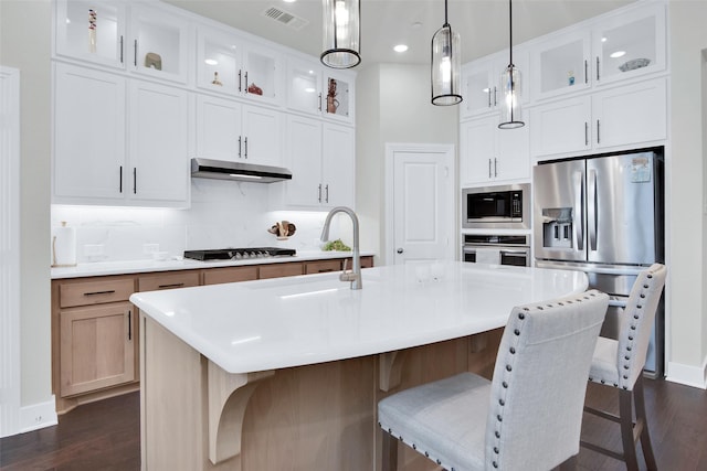 3736 Queen Rd, Sherman, TX 75090 - kitchen featuring appliances with stainless steel finishes, a sink, under cabinet range hood, dark wood finished floors, and glass insert cabinets
