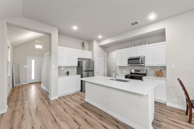 307 Bertney Dr, Princeton, TX 75071 - kitchen featuring stainless steel appliances, a sink, backsplash, white cabinets, and lofted ceiling