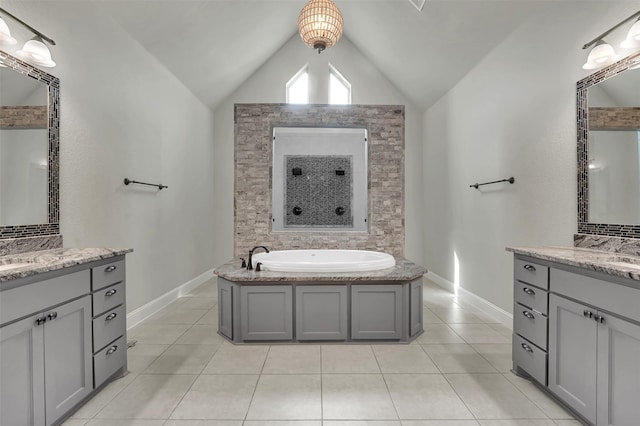 2800 Carrington Dr, Mansfield, TX 76063 - bathroom with vaulted ceiling, a garden tub, tile patterned floors, two vanities, and baseboards