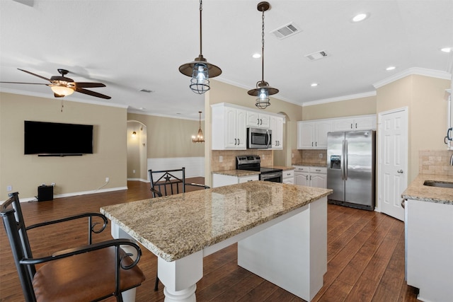 235 Carriage Dr, Willow Park, TX 76087 - kitchen with appliances with stainless steel finishes, arched walkways, crown molding, white cabinetry, and ceiling fan