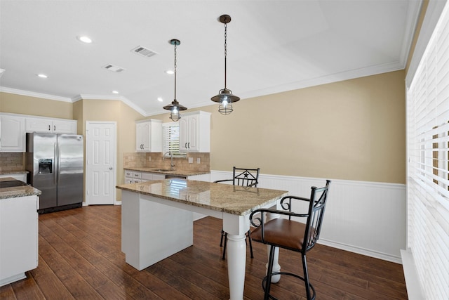 235 Carriage Dr, Willow Park, TX 76087 - kitchen with stainless steel fridge with ice dispenser, a sink, crown molding, white cabinetry, and wainscoting
