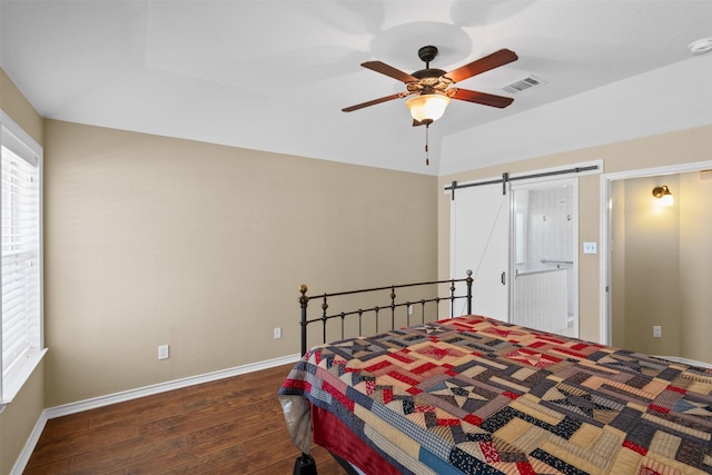 235 Carriage Dr, Willow Park, TX 76087 - bedroom featuring dark wood-style flooring, a barn door, baseboards, ceiling fan, and ensuite bath