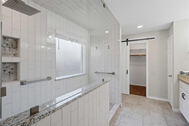 235 Carriage Dr, Willow Park, TX 76087 - full bathroom with a walk in shower, a walk in closet, vanity, baseboards, and recessed lighting