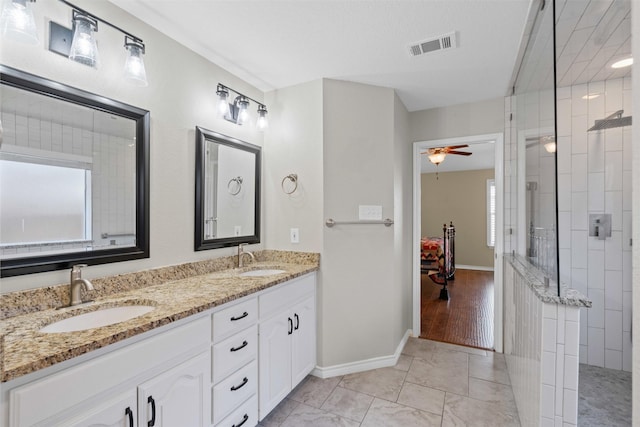 235 Carriage Dr, Willow Park, TX 76087 - full bath featuring double vanity, tiled shower, a ceiling fan, marble finish flooring, and connected bathroom