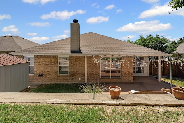 235 Carriage Dr, Willow Park, TX 76087 - back of house featuring a patio, a chimney, brick siding, a shingled roof, and an outdoor structure