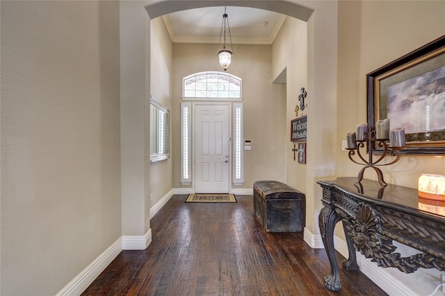 3401 Beckingham Ct, Flower Mound, TX 75022 - entrance foyer featuring arched walkways, wood finished floors, baseboards, ornamental molding, and a towering ceiling