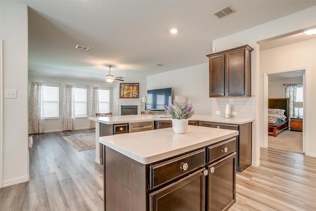 6100 True Vine Rd, Fort Worth, TX 76123 - kitchen featuring open floor plan, ceiling fan, light countertops, a fireplace, and recessed lighting