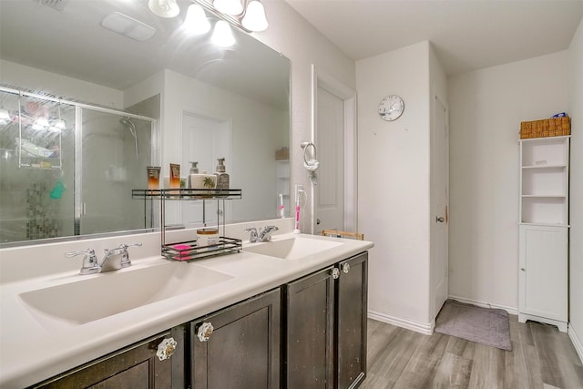 6100 True Vine Rd, Fort Worth, TX 76123 - full bath with wood finished floors, double vanity, a shower stall, and baseboards