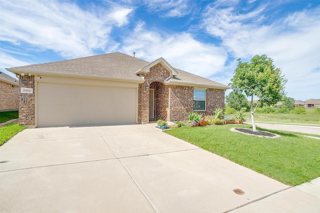 6100 True Vine Rd, Fort Worth, TX 76123 - view of front of house featuring concrete driveway, brick siding, a garage, a front lawn, and roof with shingles