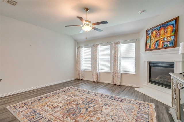 6100 True Vine Rd, Fort Worth, TX 76123 - unfurnished living room with wood finished floors, a glass covered fireplace, a ceiling fan, baseboards, and lofted ceiling