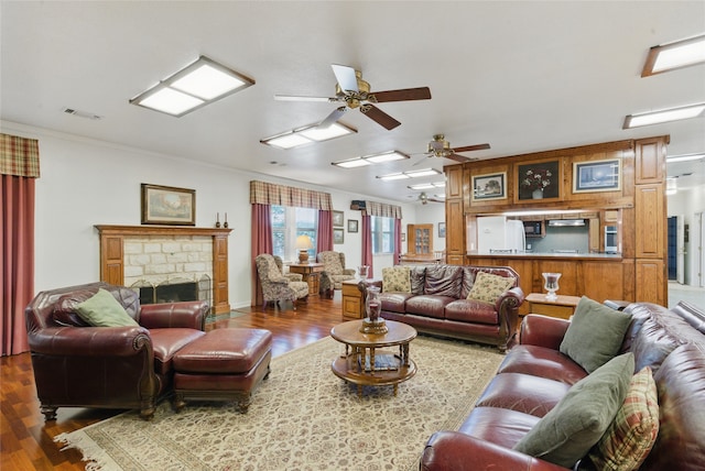 421 Olive Branch Rd, Brock, TX 76087 - living area featuring wood finished floors, a ceiling fan, ornamental molding, and a fireplace
