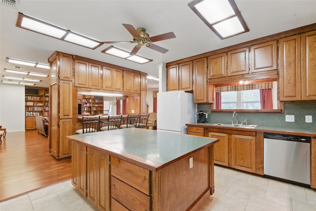 421 Olive Branch Rd, Brock, TX 76087 - kitchen with dishwasher, freestanding refrigerator, a sink, ceiling fan, and a kitchen island