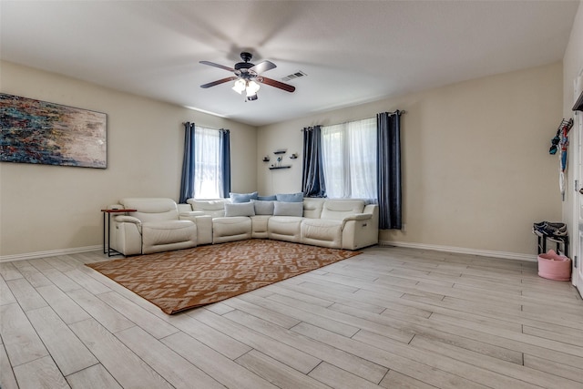 2446 Catherine St, Dallas, TX 75211 - living area with ceiling fan, light wood-style flooring, and baseboards