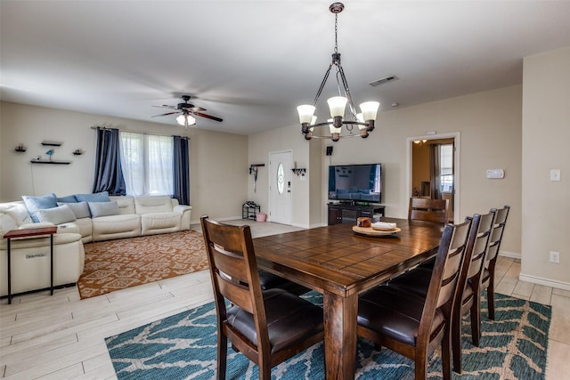 2446 Catherine St, Dallas, TX 75211 - dining area with light wood-type flooring, a chandelier, and a ceiling fan
